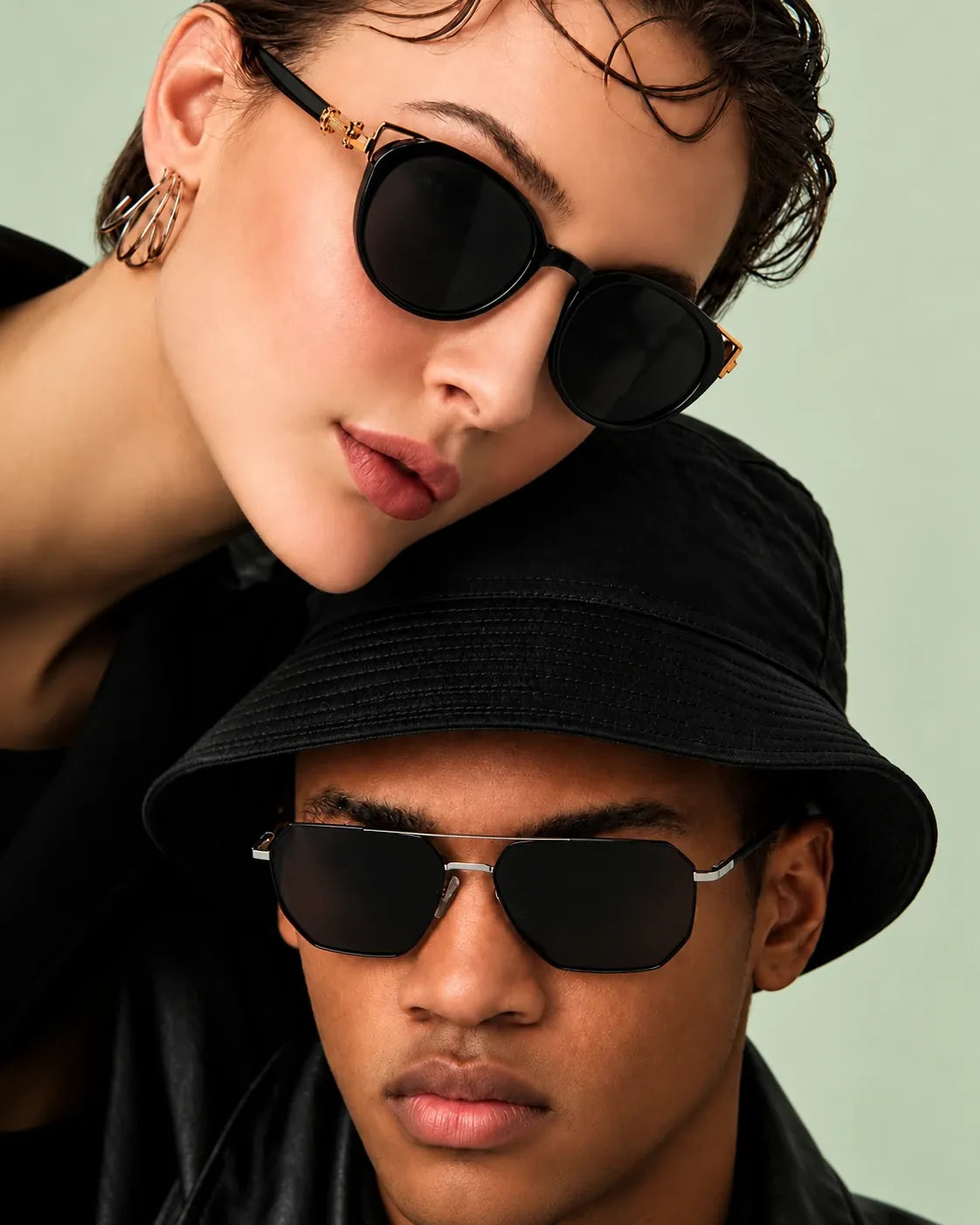 Woman and man in black sunglasses and a bucket hat