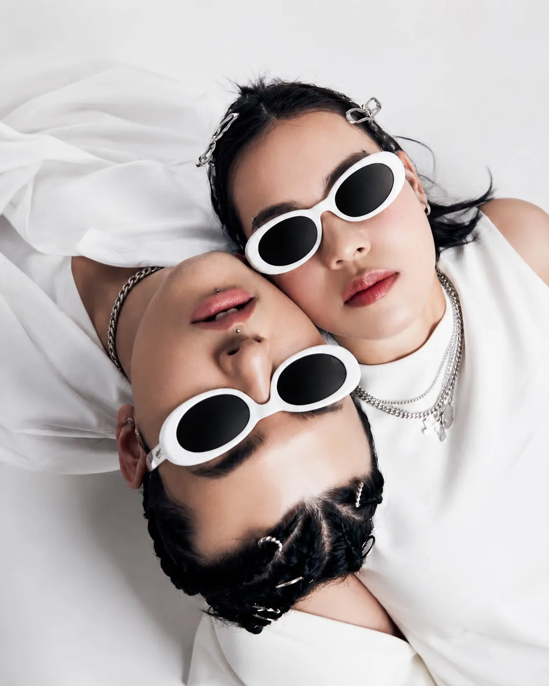 Two people in white oval sunglasses